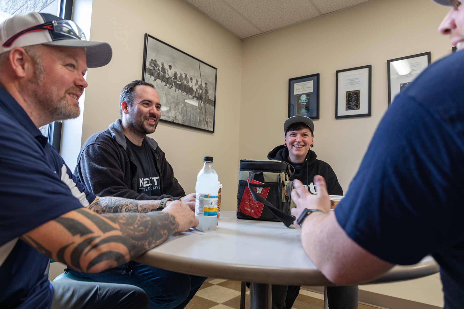 4 employees sitting at table - commitment to employees