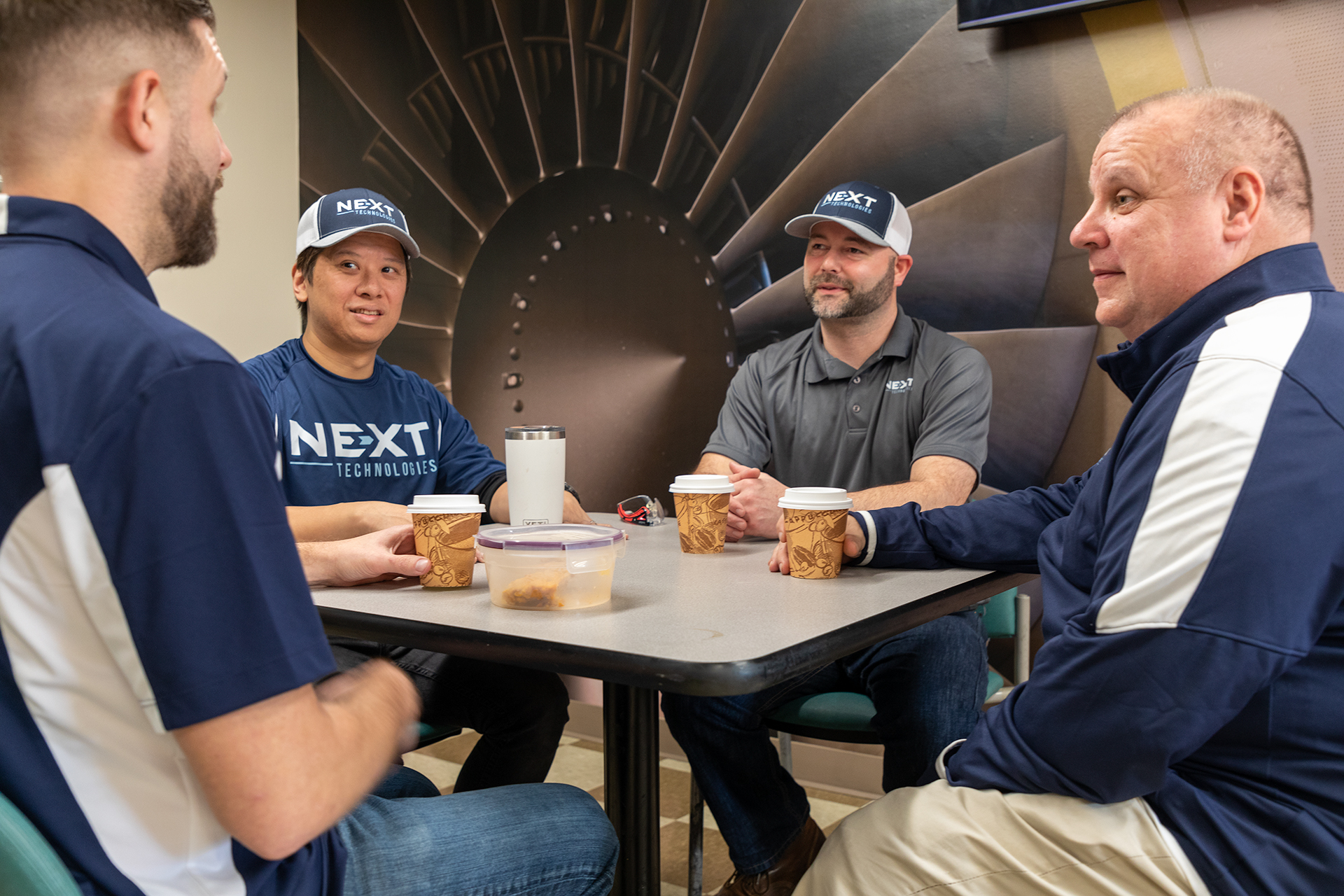 group of 4 men at table